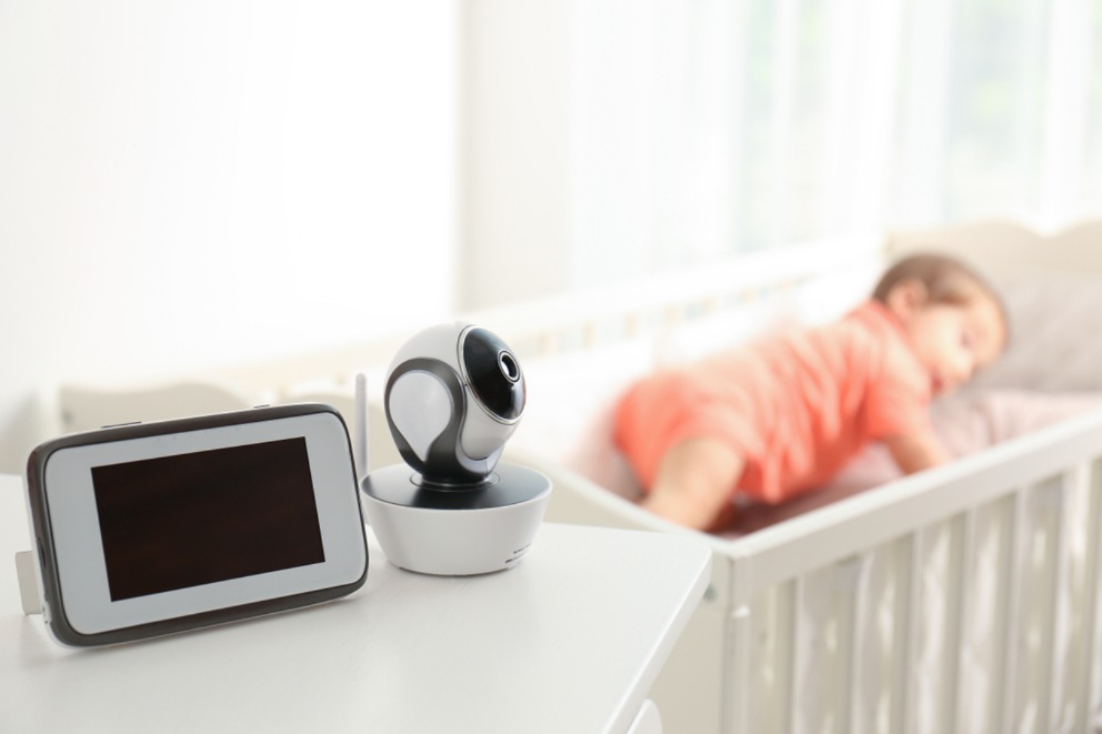 Safe placement of baby monitor next to a crib, not inside it.